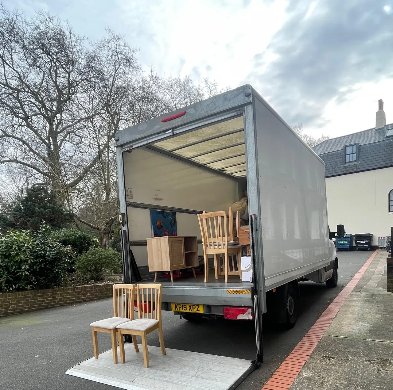 Fastiya movers carrying packed boxes into a property