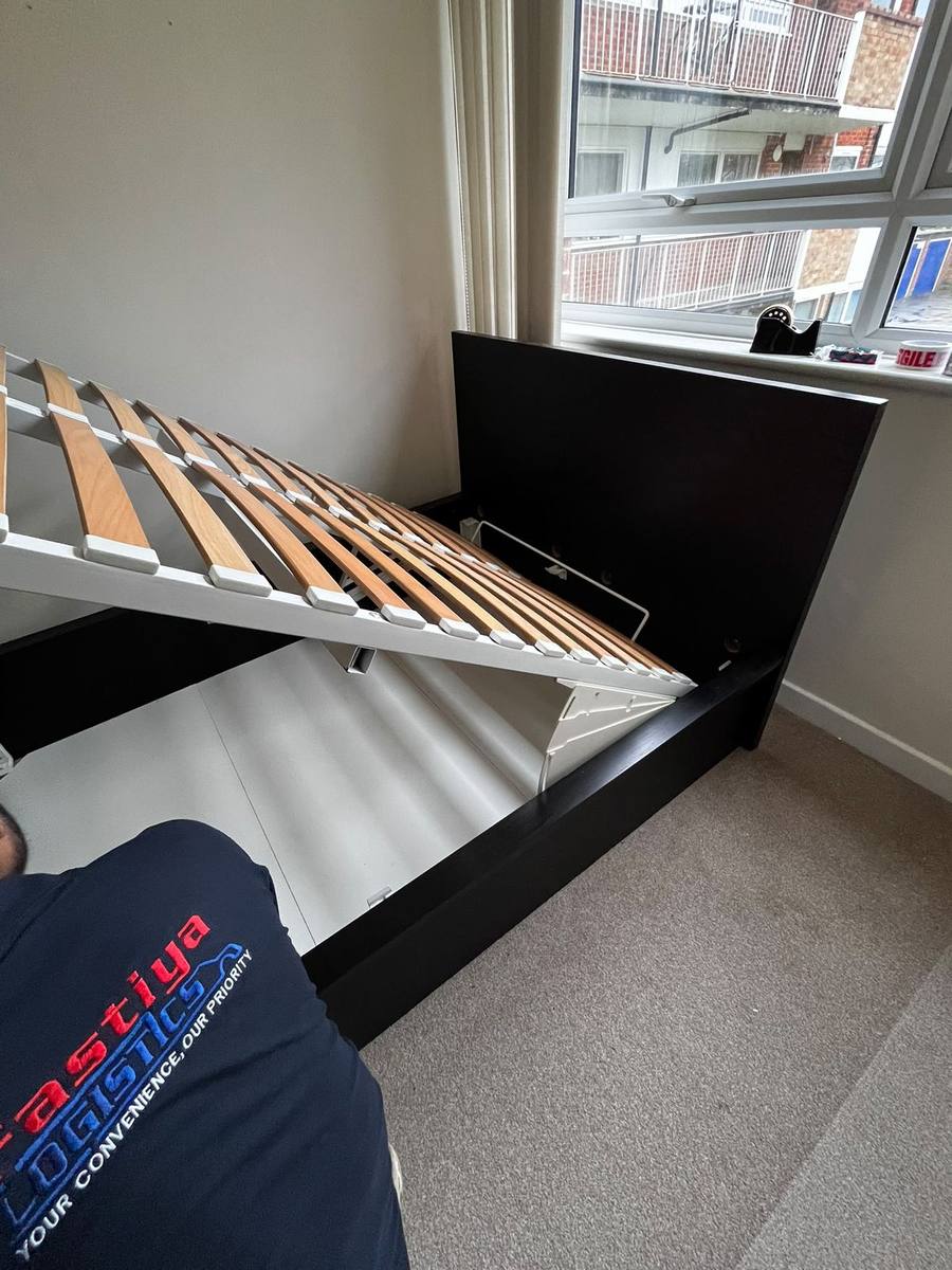 A bed frame reassembled in the new room