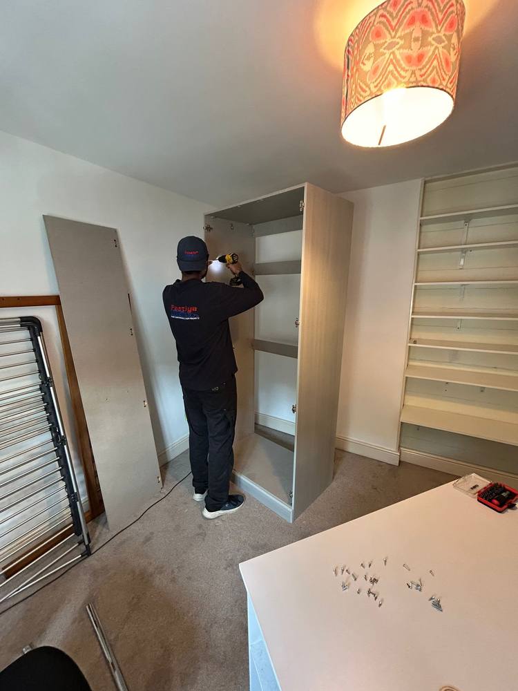 A Fastiya Logistics mover fitting shelves into a wardrobe