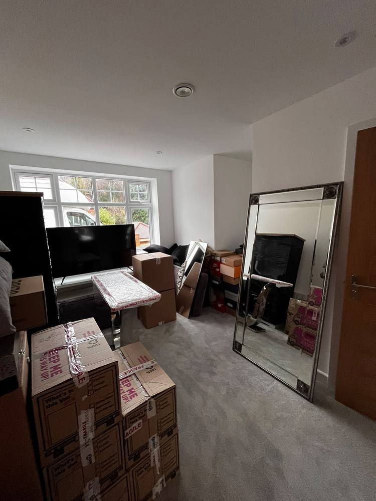 A bedroom packed into labelled boxes ready for a house move