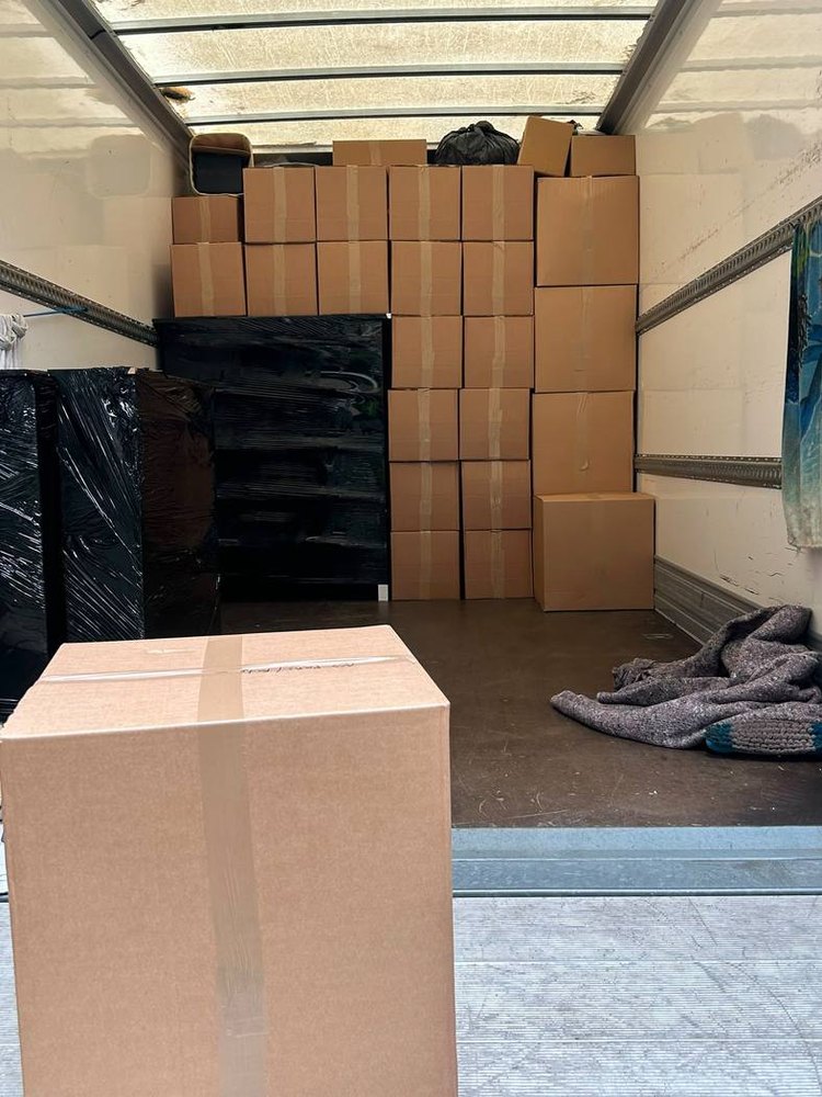 The same van packed to the roof with wrapped furniture and labelled boxes