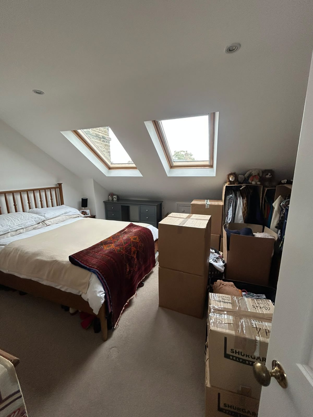 A bedroom packed and stacked by the door, ready to carry down to the van