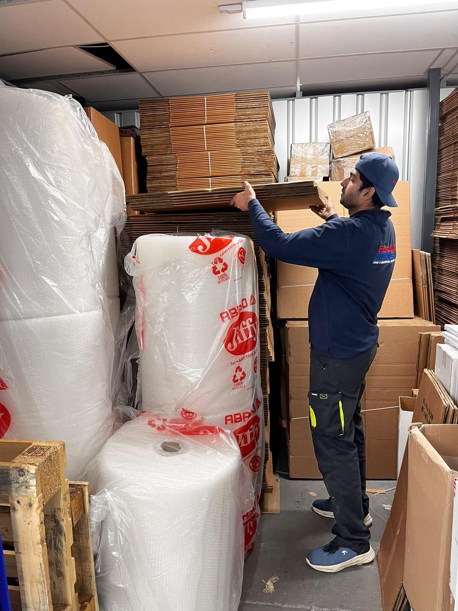 A Fastiya Logistics team member stacking boxes and bubble wrap in the materials store