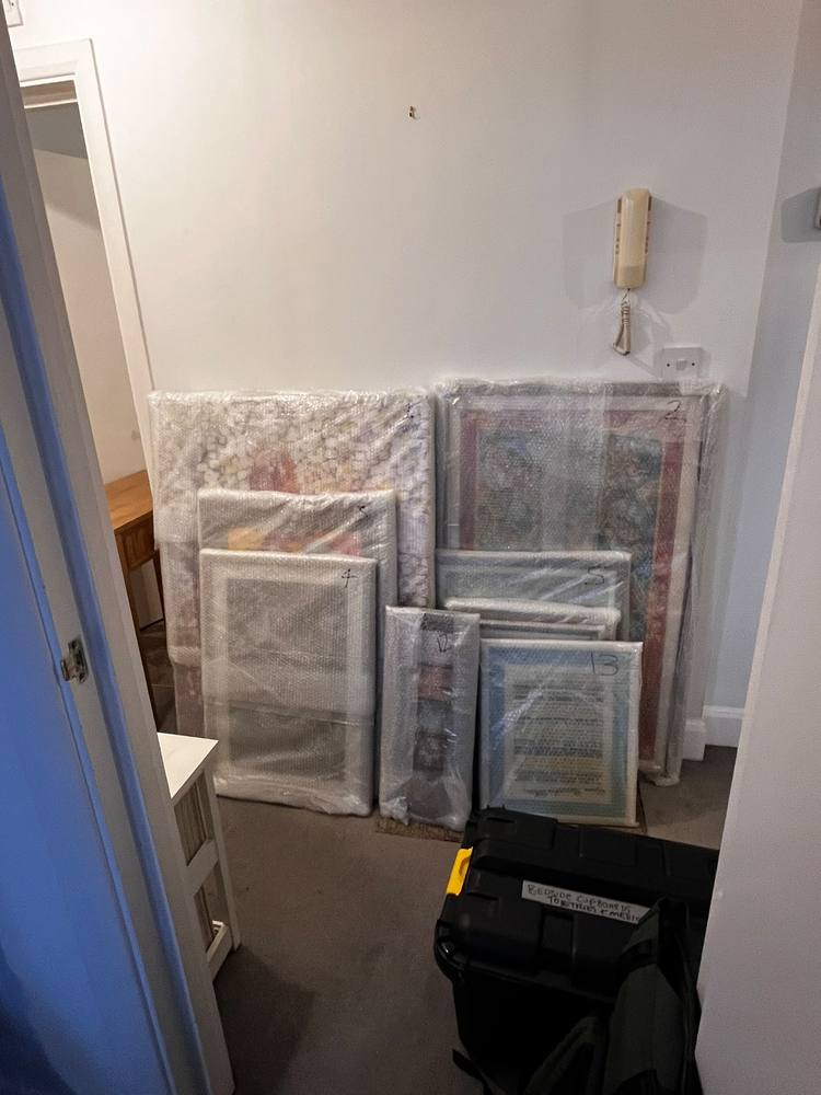 Framed pictures bubble-wrapped and numbered