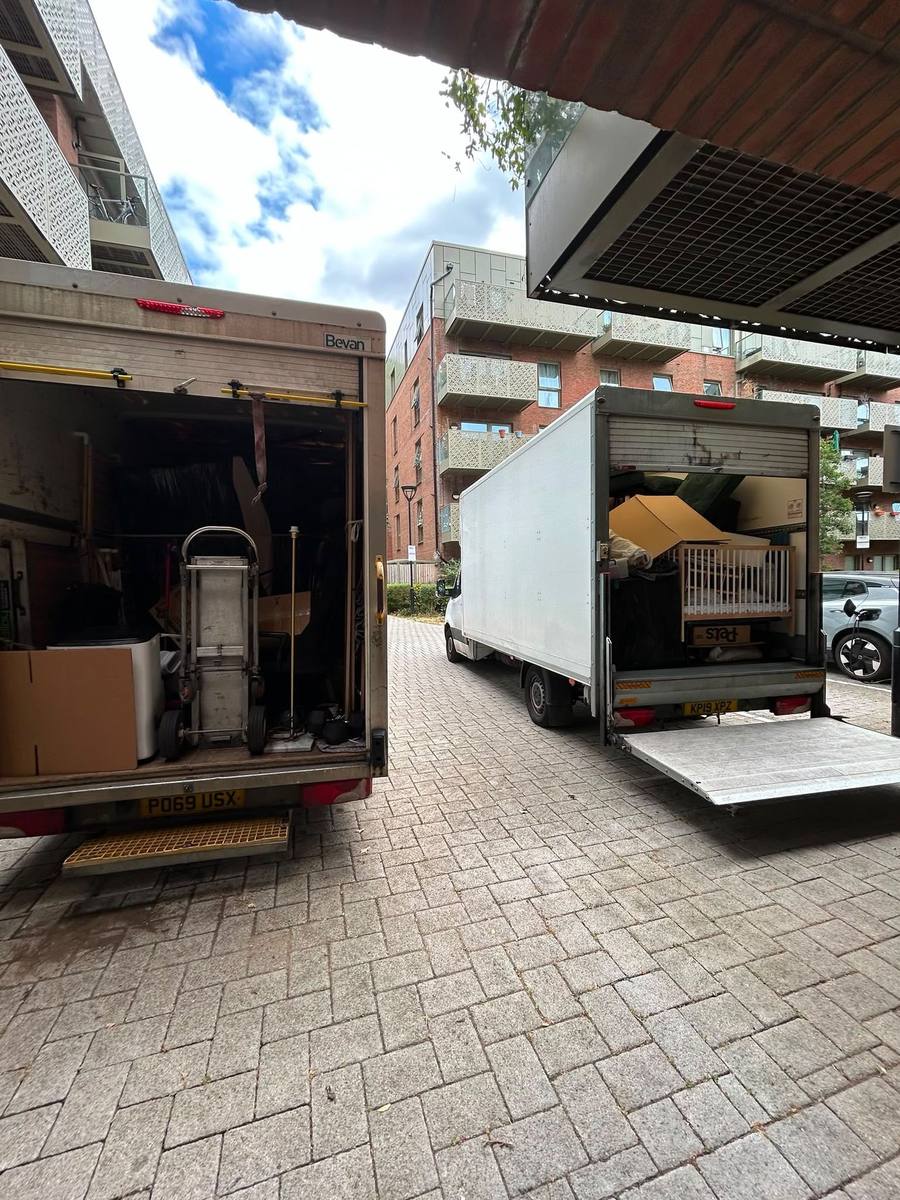 Two Fastiya Logistics vans with tail lifts down outside a London development