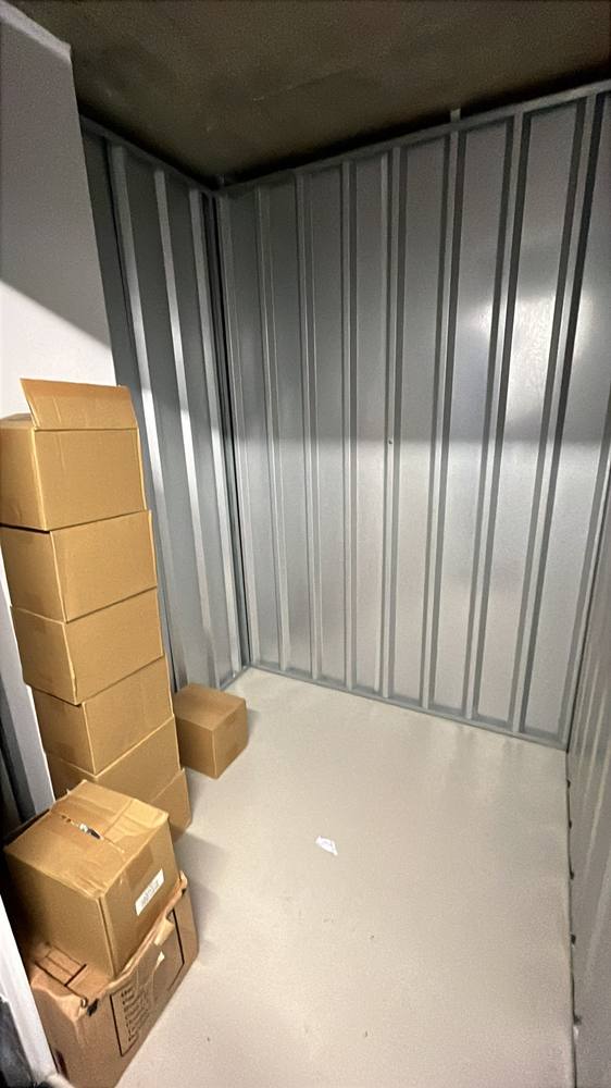 Labelled boxes stacked inside a clean secure storage unit